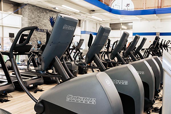 Row of Precor cardio machines inside the gym at Steel Fitness Premier.