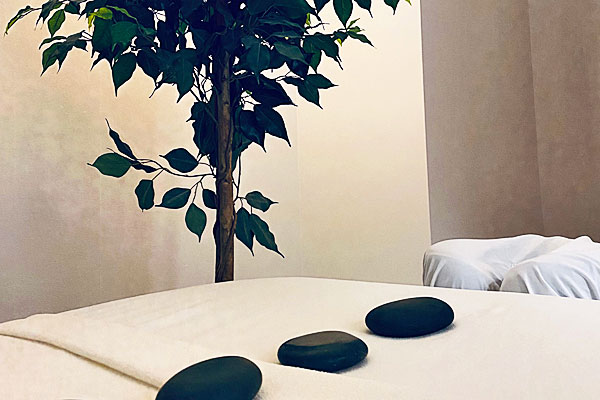 Massage table with hot stones