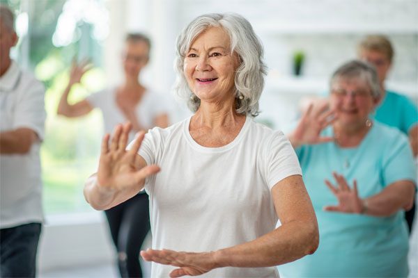 Woman participating in a tai chi class.
